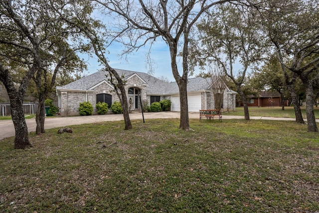 single story home featuring a front lawn and a garage