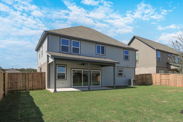 back of property featuring ceiling fan, cooling unit, a yard, and a patio