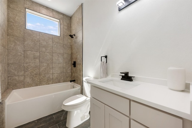 full bathroom with toilet, tiled shower / bath, and vanity