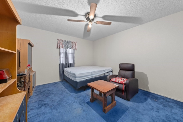 carpeted bedroom with ceiling fan and a textured ceiling