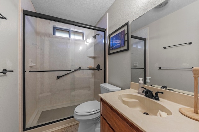 bathroom with a shower with door, a textured ceiling, toilet, and vanity