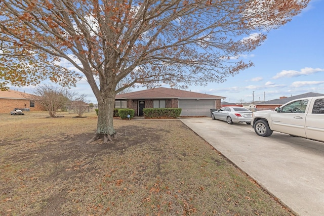 ranch-style house with a garage and a front yard