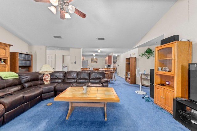 carpeted living room featuring ceiling fan and vaulted ceiling