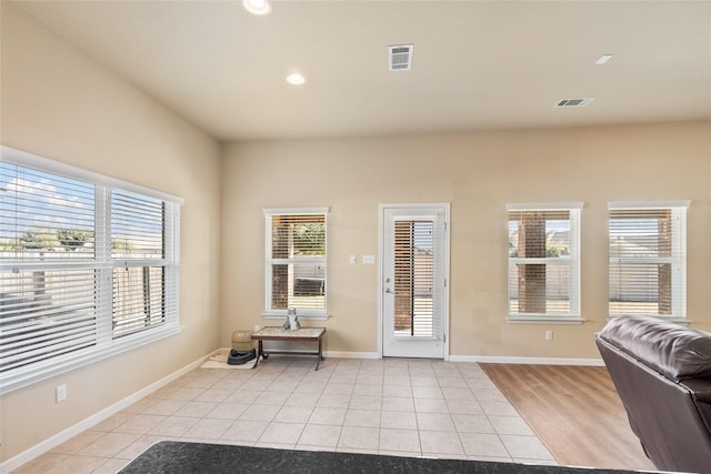 doorway to outside featuring light tile patterned flooring