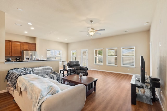 living room featuring ceiling fan, wood-type flooring, and plenty of natural light