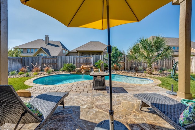 view of swimming pool featuring pool water feature and a patio