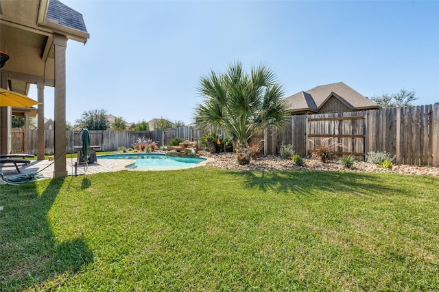 view of yard with a patio area and a fenced in pool