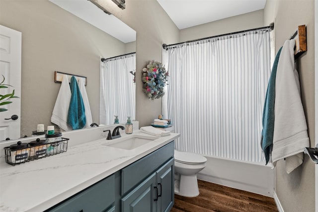 full bathroom with vanity, wood-type flooring, shower / tub combo, and toilet