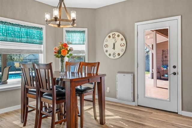 1536 Kings Ranch Rd, Bandera, TX 78003 - dining space with a chandelier, light wood-style floors, and baseboards