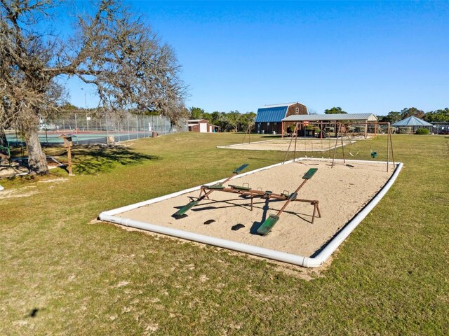 view of property's community featuring a lawn and a playground