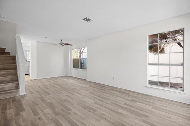 unfurnished living room featuring ceiling fan and light hardwood / wood-style floors