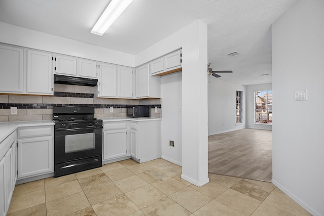 kitchen featuring ceiling fan, white cabinetry, black range with gas stovetop, and decorative backsplash