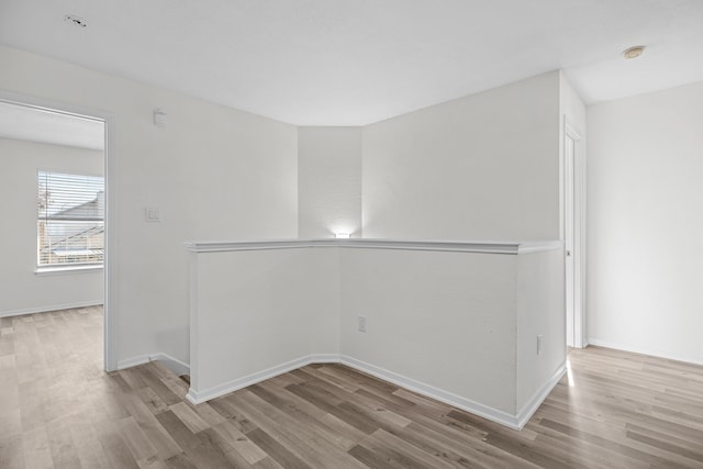 empty room with light hardwood / wood-style flooring