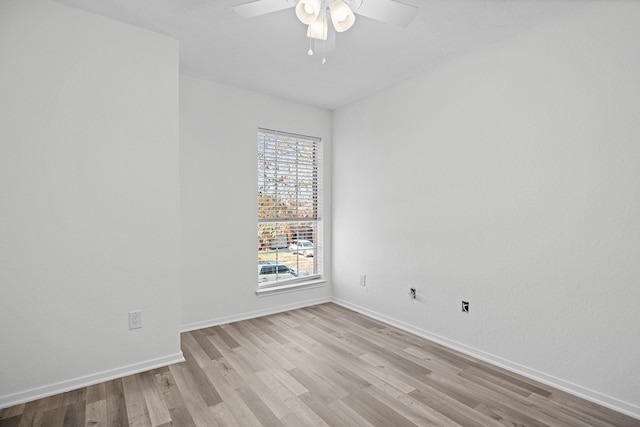 empty room featuring ceiling fan and light hardwood / wood-style flooring