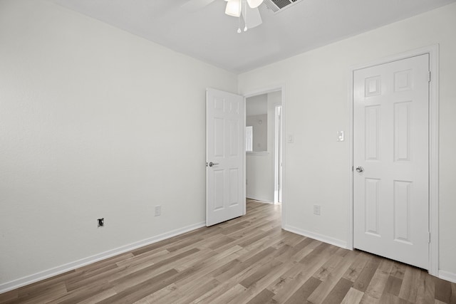 unfurnished bedroom with ceiling fan and light hardwood / wood-style flooring