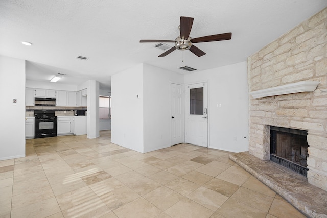 unfurnished living room with ceiling fan and a fireplace