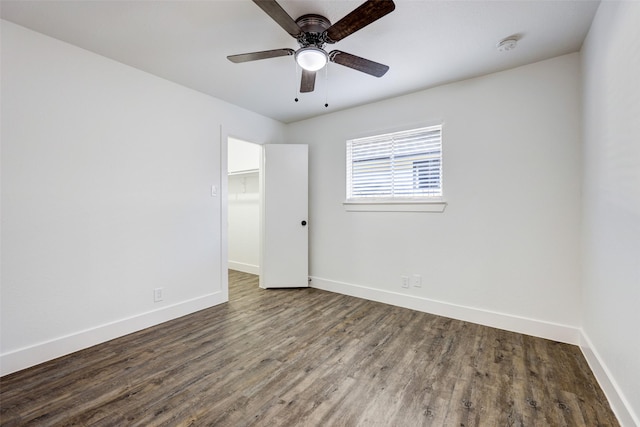 spare room featuring ceiling fan and dark hardwood / wood-style flooring