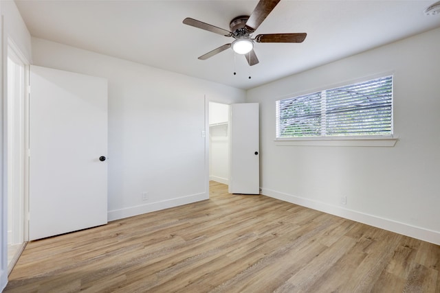 empty room featuring ceiling fan and light hardwood / wood-style flooring