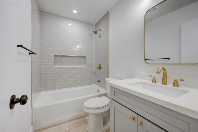 full bathroom featuring toilet, tiled shower / bath combo, tile patterned floors, and vanity