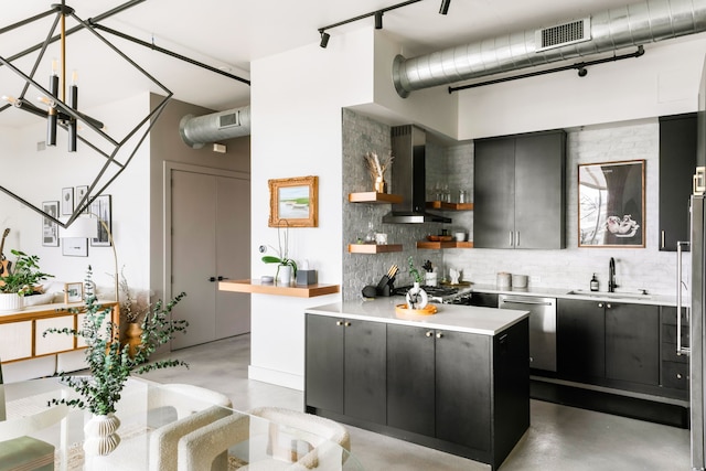 kitchen featuring dishwasher, wall chimney range hood, a center island, decorative backsplash, and sink