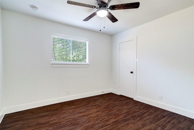 empty room featuring ceiling fan and dark wood-type flooring