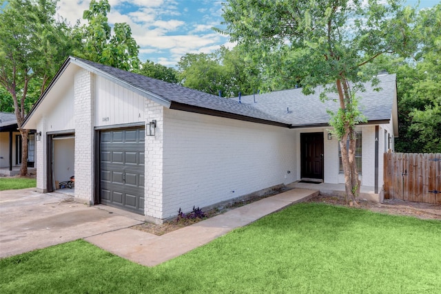 ranch-style home with a front lawn and a garage