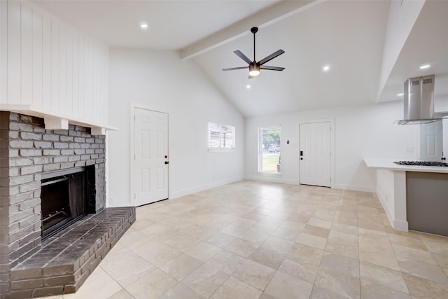 unfurnished living room featuring beam ceiling, ceiling fan, a brick fireplace, and high vaulted ceiling