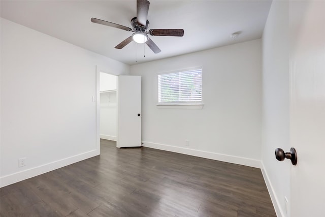 unfurnished room featuring ceiling fan and dark hardwood / wood-style flooring