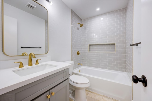 full bathroom featuring toilet, tile patterned floors, tiled shower / bath, and vanity