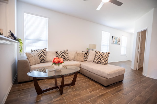 living room featuring ceiling fan and a wealth of natural light