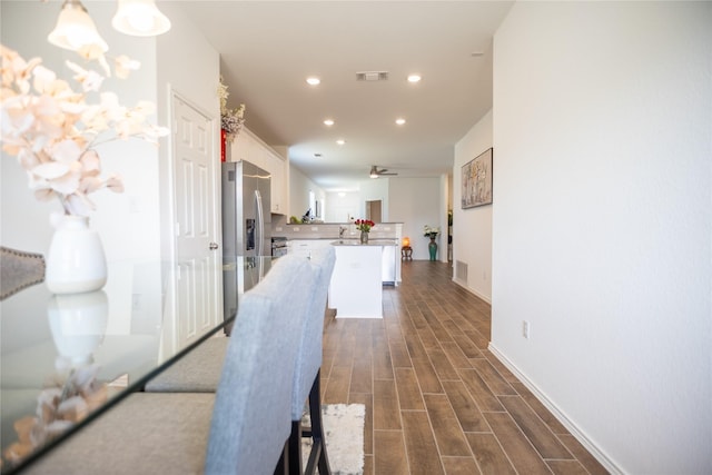 interior space featuring ceiling fan, recessed lighting, visible vents, and wood tiled floor