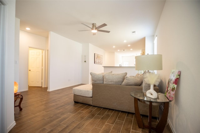 living area featuring a ceiling fan, visible vents, baseboards, recessed lighting, and dark wood-style flooring