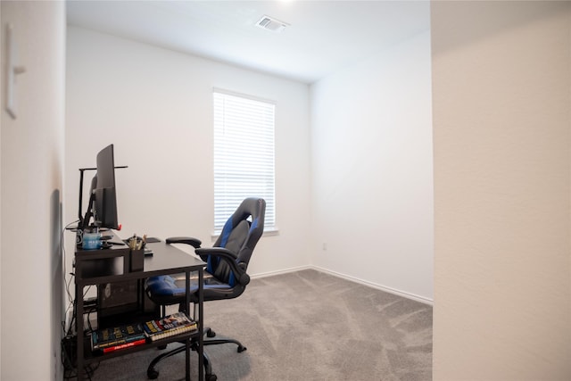 carpeted office space with visible vents and baseboards