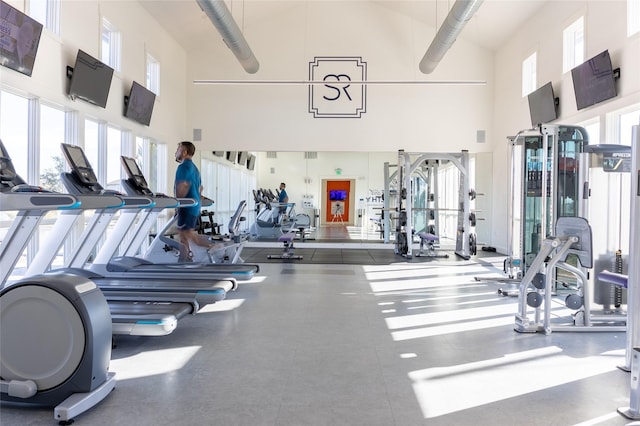 gym featuring a towering ceiling