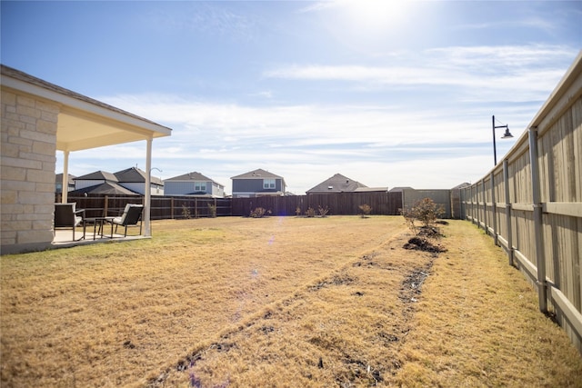 view of yard with a patio and a fenced backyard