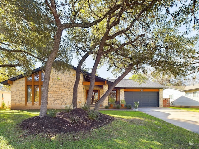 view of front of home featuring a garage and a front lawn