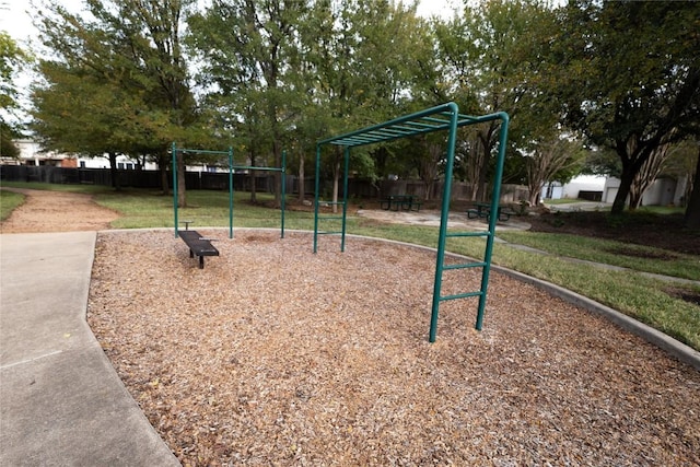 view of property's community with a playground and a lawn