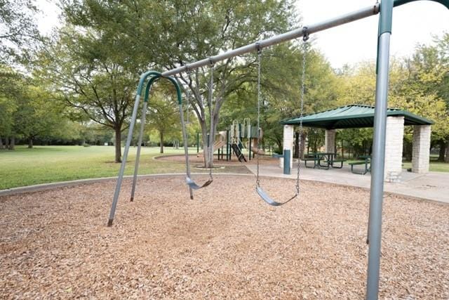 view of community featuring a lawn and a playground