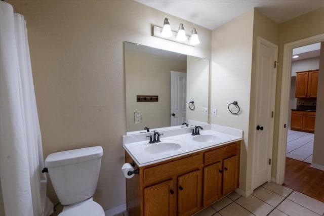 bathroom featuring tile patterned floors, vanity, and toilet