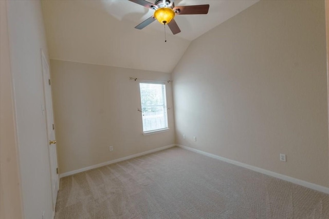 carpeted spare room with lofted ceiling and ceiling fan