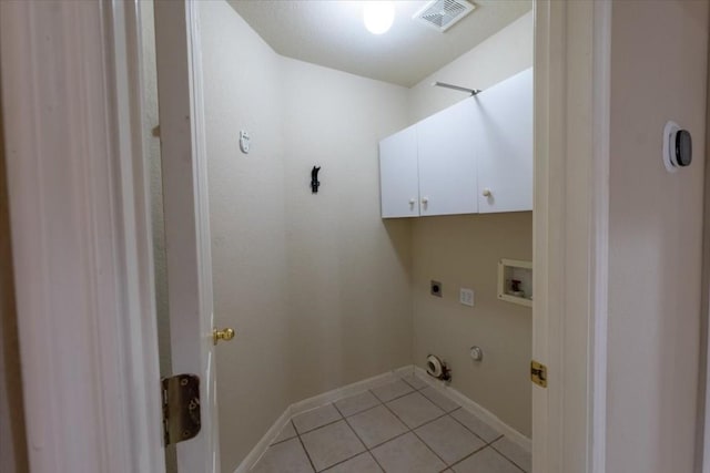 laundry area with electric dryer hookup, hookup for a washing machine, cabinets, light tile patterned flooring, and hookup for a gas dryer