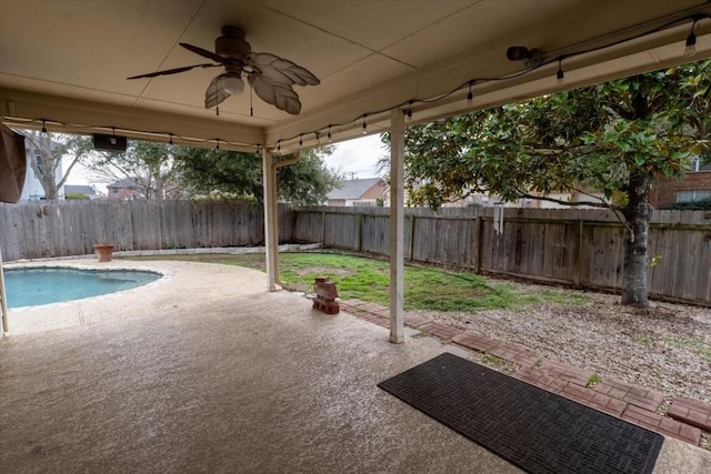 view of patio featuring ceiling fan and a fenced in pool