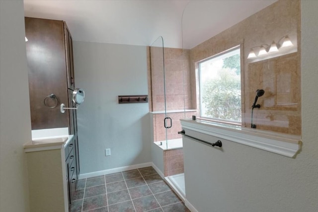 bathroom with vanity, an enclosed shower, and tile patterned flooring