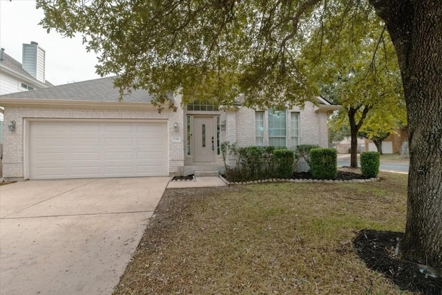 view of front of property featuring a garage and a front lawn