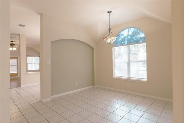 tiled empty room with lofted ceiling and ceiling fan