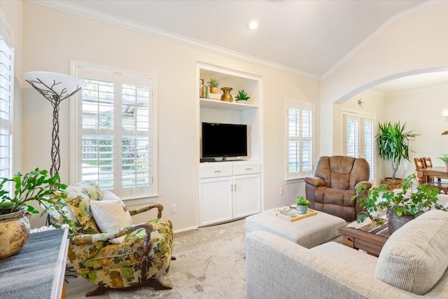 carpeted living room with ornamental molding and built in shelves