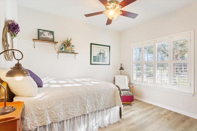 bedroom with ceiling fan and light hardwood / wood-style floors