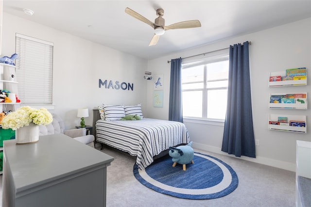 carpeted bedroom featuring ceiling fan and baseboards