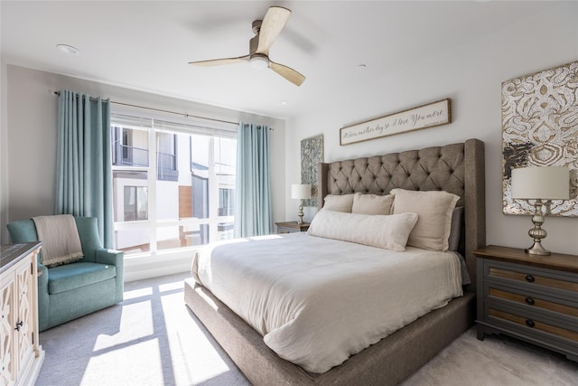 bedroom with a ceiling fan and light colored carpet