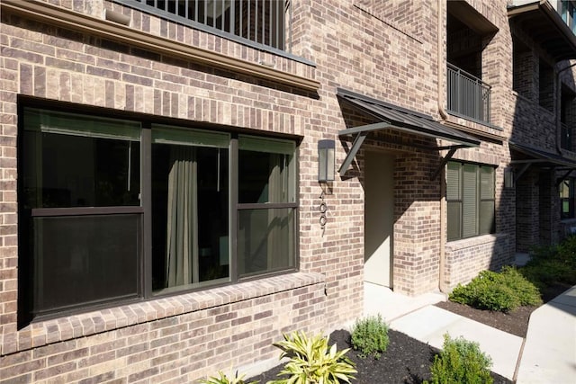 4007 Emory Peak Pass, Austin, TX 78731 - view of side of home featuring a balcony and brick siding